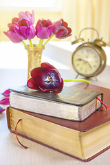 Image showing Holy Bible and old gold alarm clock on wood table