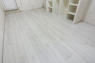 Image showing Bright laminate is laid in a renovated residential building