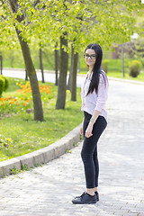 Image showing Teenager brunette girl walking in park