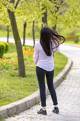 Image showing Teenager brunette girl walking in park