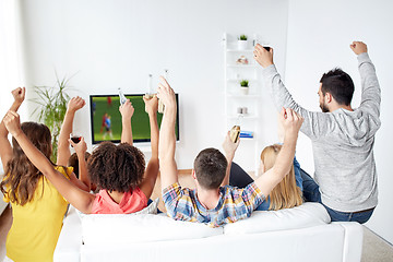 Image showing friends watching soccer on tv and celebrating goal