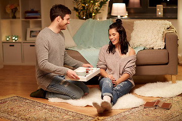 Image showing happy couple with food on tray at home