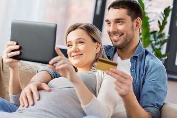 Image showing man and pregnant wife shopping online at home