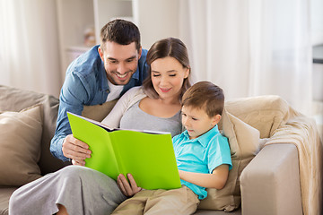 Image showing happy family reading book at home