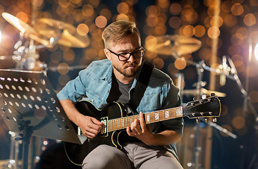 Image showing man playing guitar at studio rehearsal