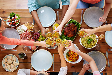 Image showing people having dinner and clinking wine glasses