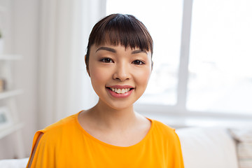 Image showing portrait of smiling young asian woman at home