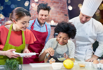 Image showing happy friends and chef cook baking in kitchen