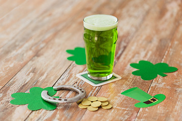 Image showing glass of green beer, horseshoe and gold coins