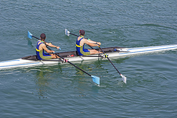 Image showing Two young rowers in a racing rower boat