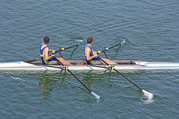 Image showing Two young rowers in a racing rower boat