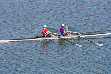 Image showing Two young rowers in a racing rower boat