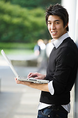 Image showing Asian student with laptop