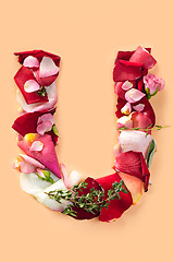 Image showing Letter U made from red roses and petals isolated on a white background