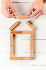 Image showing Man and wooden cubes on table. Management concept