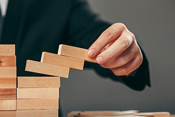 Image showing Man and wooden cubes on table. Management concept