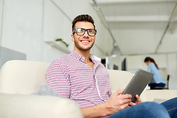 Image showing man in glasses with tablet pc working at office