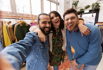 Image showing friends taking selfie at vintage clothing store