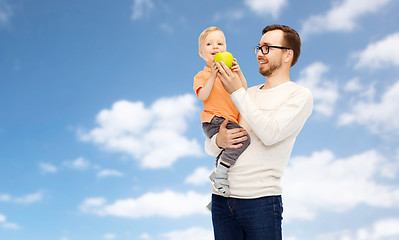 Image showing happy father and little son with green apple