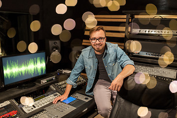 Image showing man at mixing console in music recording studio