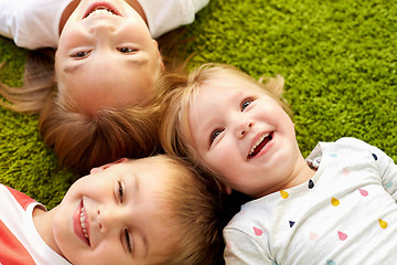 Image showing happy little kids lying on floor or carpet