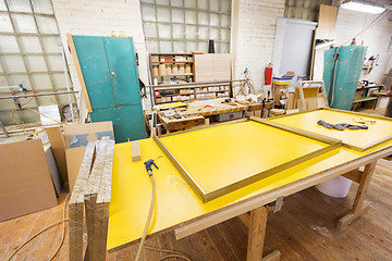 Image showing glue gun and frame on workbench at workshop