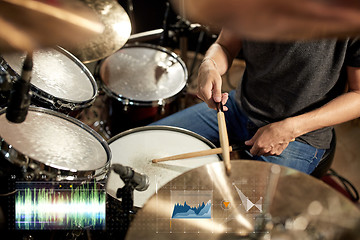 Image showing male musician playing drum kit at concert