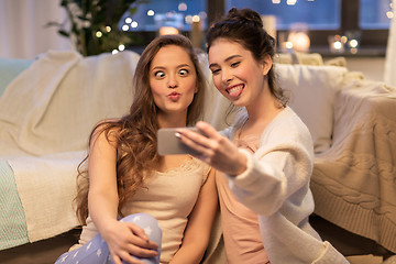 Image showing female friends taking selfie by smartphone at home