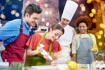 Image showing happy friends and chef cook baking in kitchen