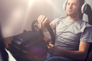 Image showing close up of man playing car racing video game