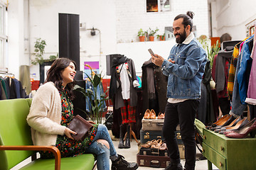 Image showing couple choosing clothes at vintage clothing store