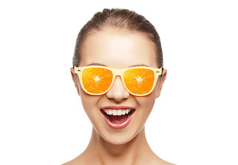 Image showing happy teenage girl in sunglasses with oranges