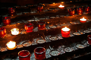 Image showing burnig candles at the altar in cathedral