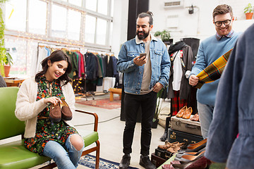 Image showing friends choosing clothes at vintage clothing store