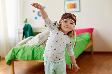 Image showing happy little girl in pilot hat playing at home