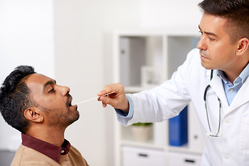 Image showing doctor examining patient throat at clinic