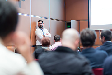 Image showing Skiled Businessman Presenting a Project to His Work Team at Informal Company Meeting.