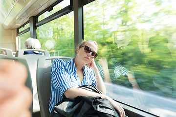 Image showing Portrait of tired woman sleeping on bus.