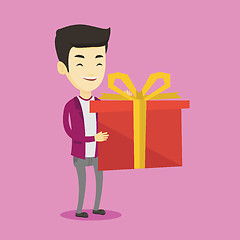 Image showing Joyful asian man holding box with gift.