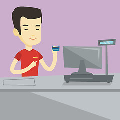 Image showing Cashier holding credit card at the checkout.