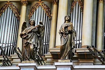 Image showing metalic statues near organ