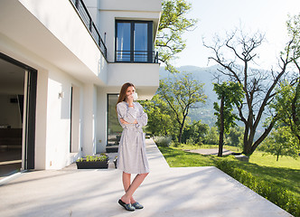 Image showing woman in a bathrobe enjoying morning coffee