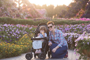 Image showing mother and daughter in flower garden