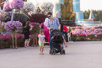 Image showing mother and daughter walking in flower garden