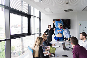 Image showing boss dresed as bear having fun with business people in trendy of