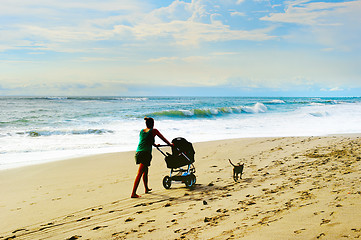 Image showing Beach walking with baby carriage 