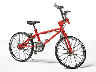 Image showing Vintage metal white bicycle toy over wooden table