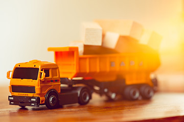 Image showing The toy car and building truck on wooden table