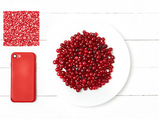 Image showing bowl of cowberries on old wooden table