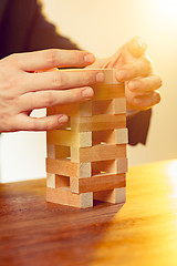 Image showing Man and wooden cubes on table. Management concept